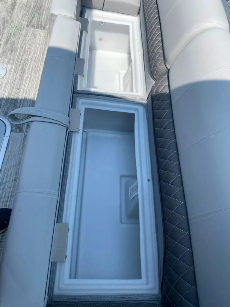 Slide: The Image of 2024 Ranger Reata 223C boat seating with built-in storage compartments. - 10