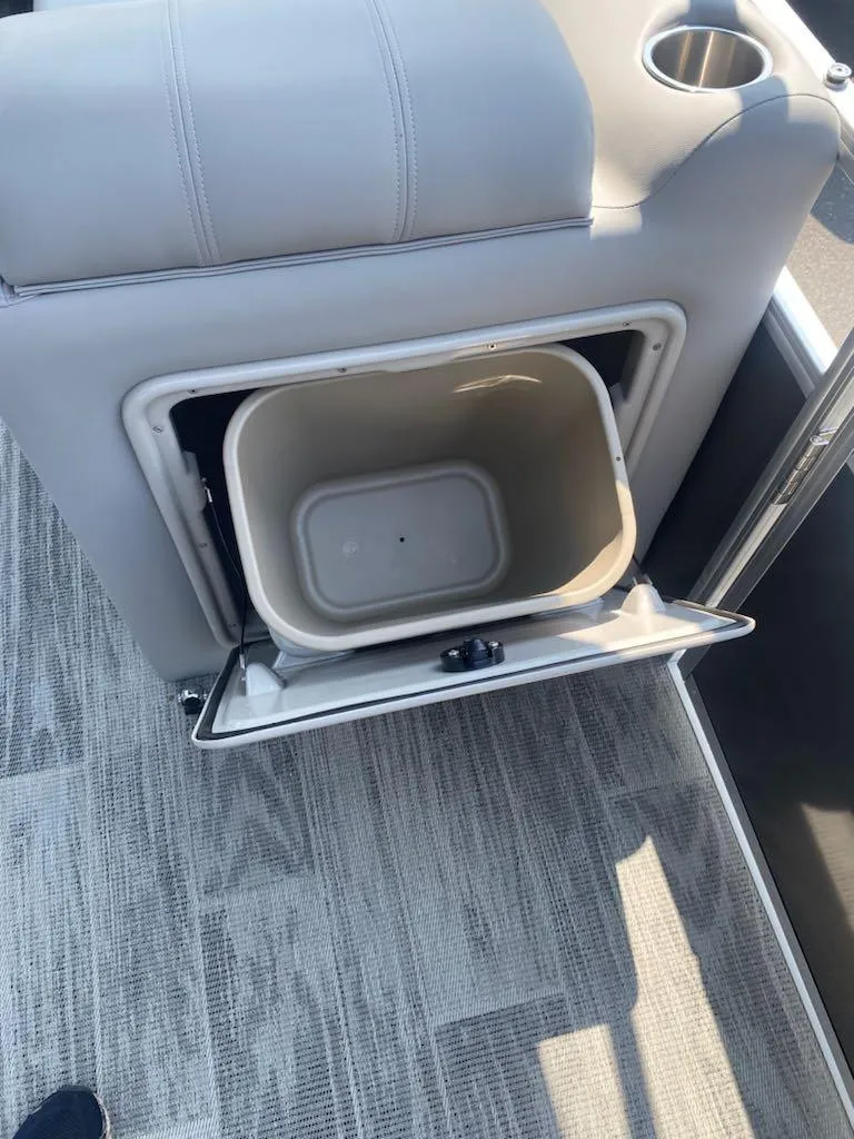 Slide: The Image of 2024 Ranger Reata 223C boat interior with built-in storage compartment. - 12