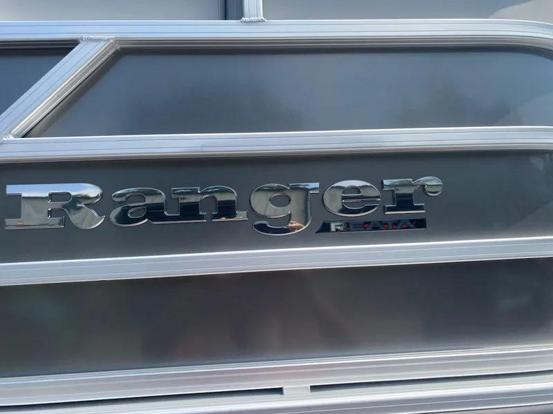 Slide: The Image of 2024 Ranger Reata 223C boat logo on metallic surface. - 17