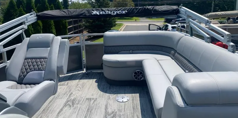 Slide: The Image of 2024 Ranger Reata 223C pontoon boat with luxurious gray seating and modern design. - 3