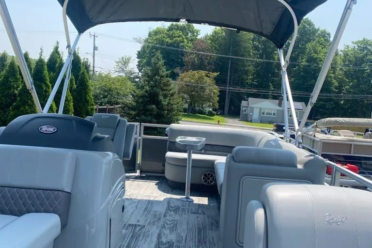 Slide: The Image of 2024 Ranger Reata 223C pontoon boat with spacious seating and canopy. - 4