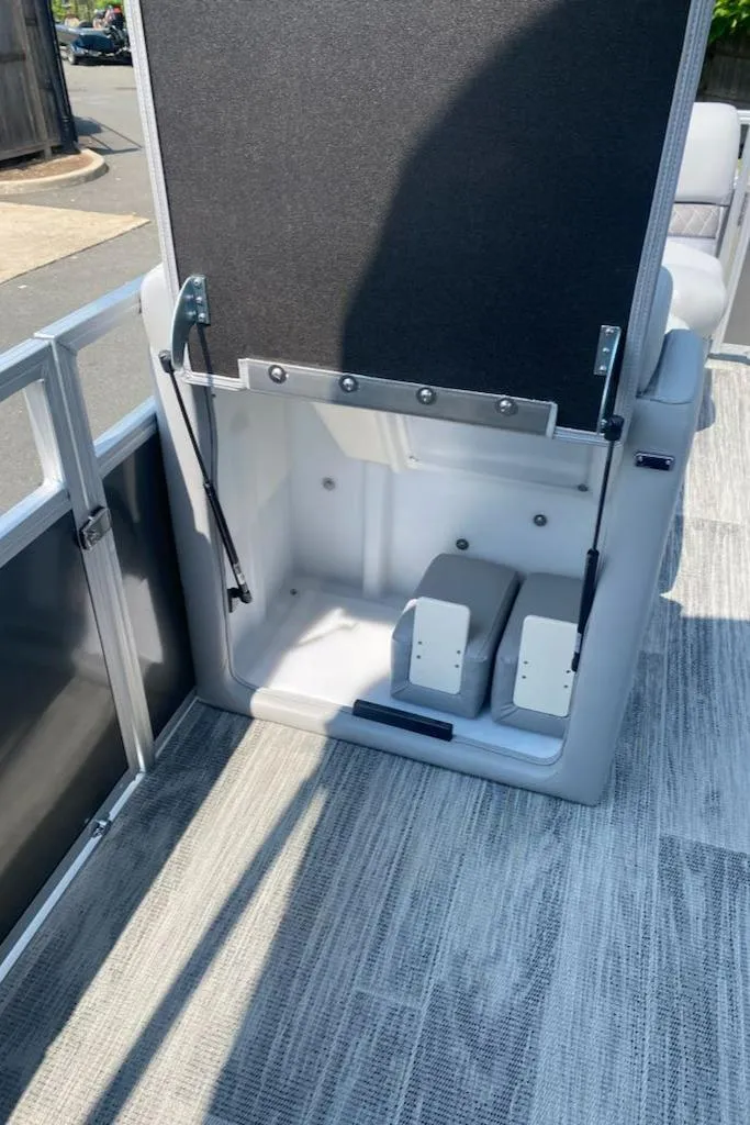 Slide: The Image of 2024 Ranger Reata 223C boat interior storage compartment with open lid. - 5