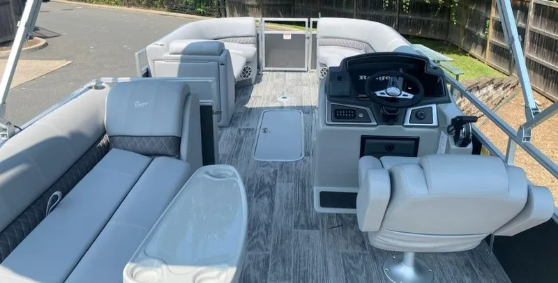 Slide: The Image of 2024 Ranger Reata 223C pontoon boat interior with modern seating and helm. - 6