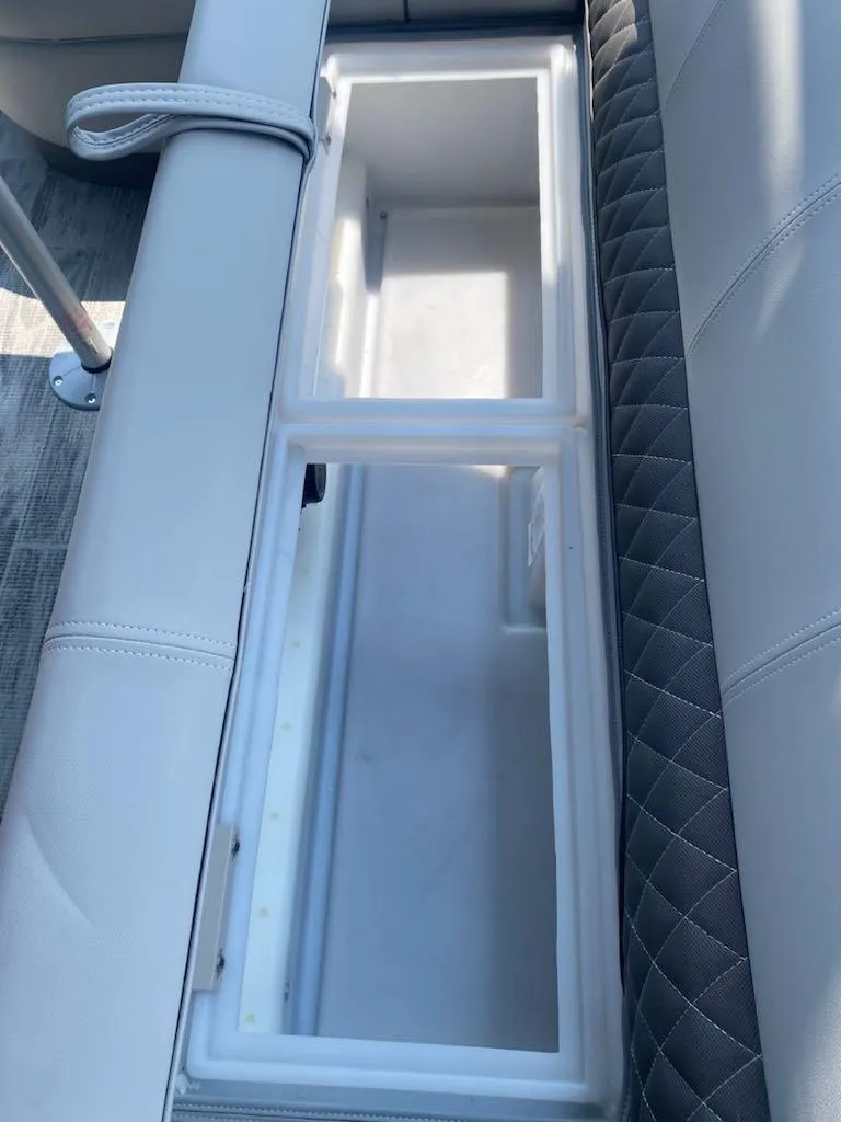 Slide: The Image of 2024 Ranger Reata 223C boat seat storage compartment, open and empty. - 9