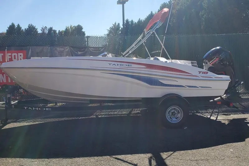Slide: The Image of 2024 Tahoe T18 boat on trailer, side view, outdoors. - 1