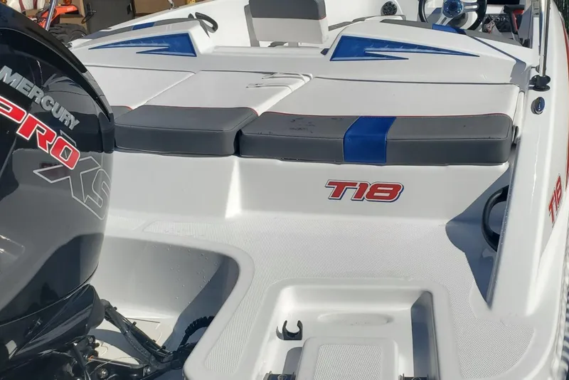 Slide: The Image of 2024 Tahoe T18 boat with Mercury Pro XS engine, white and blue seating. - 3