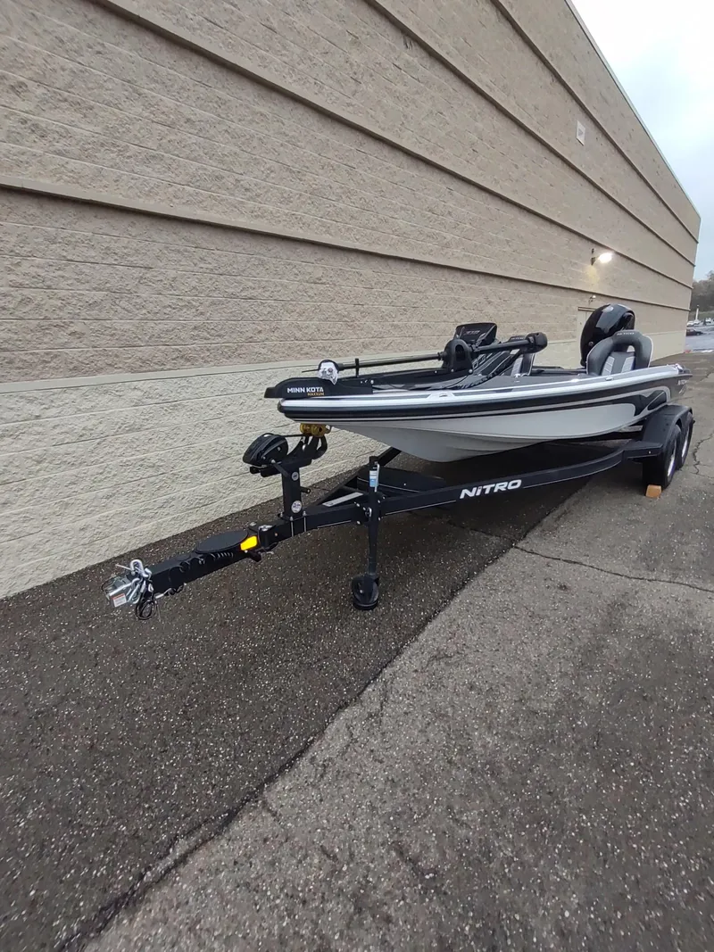 Slide: The Image of 2024 Nitro Z18 boat on trailer parked beside a building. - 1