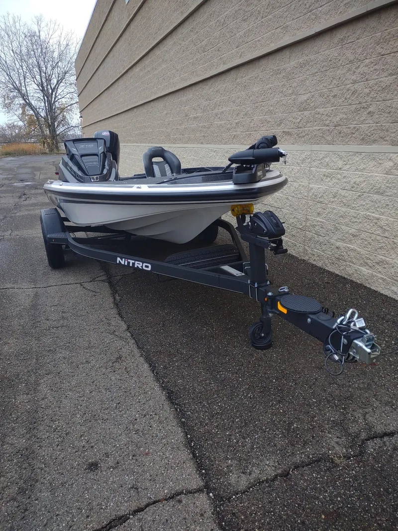 Slide: The Image of 2024 Nitro Z18 boat on trailer, parked outdoors near a building. - 3