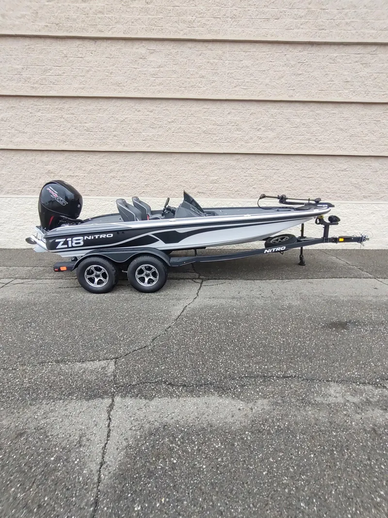 Slide: The Image of 2024 Nitro Z18 boat with trailer, parked against a beige wall. - 4