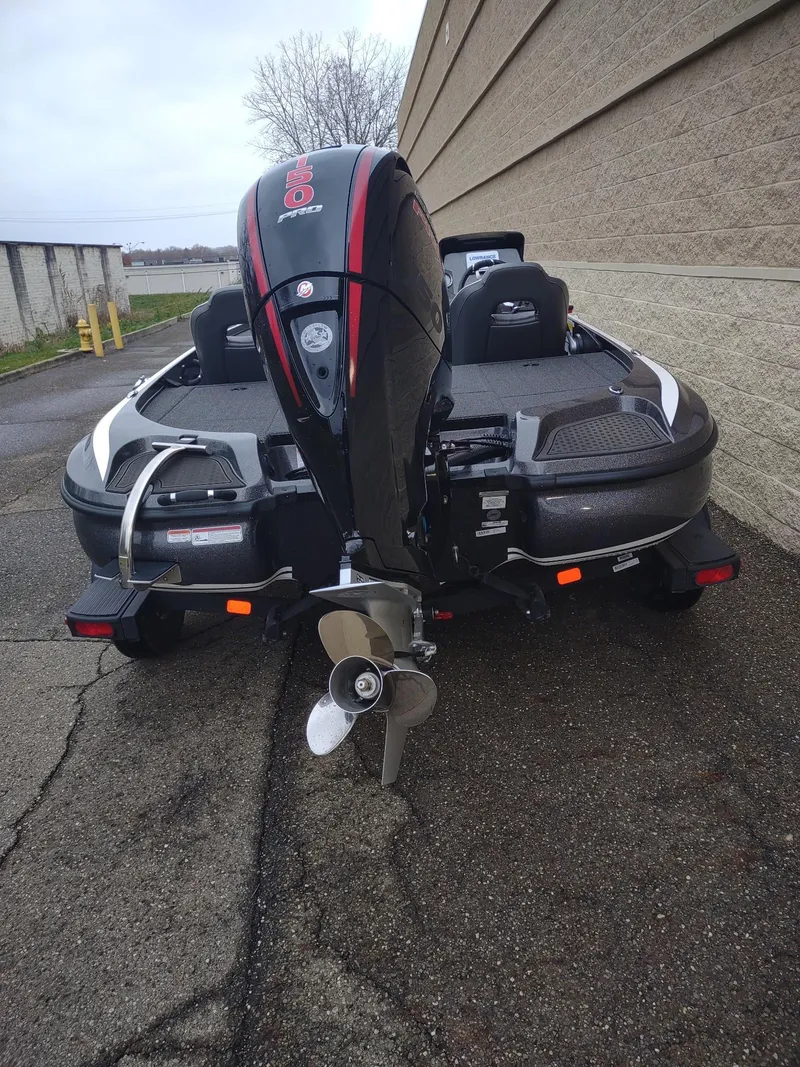 Slide: The Image of 2024 Nitro Z18 boat with powerful outboard motor, parked on a paved surface. - 5