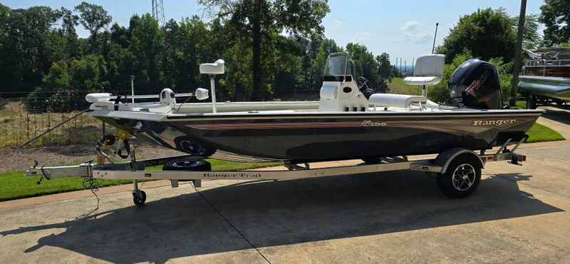 Slide: The Image of 2024 Ranger RB190 boat on trailer, parked outdoors, side view. - 1