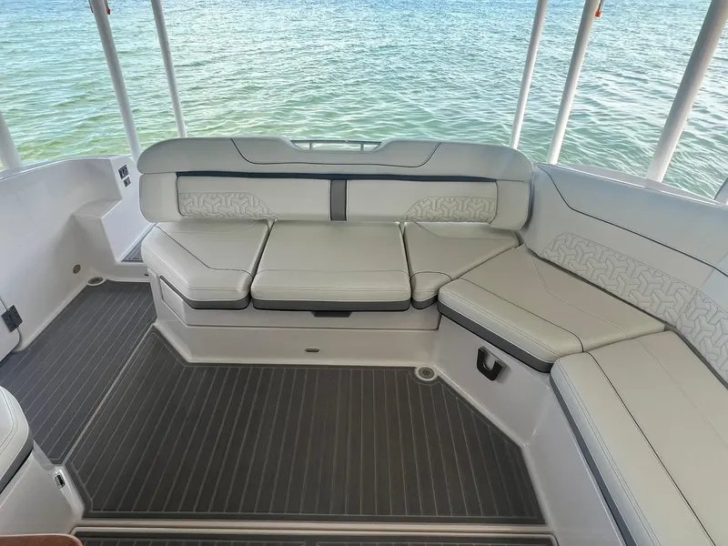 Slide: The Image of 2022 Regal LS36 boat interior with white seating and ocean view. - 15