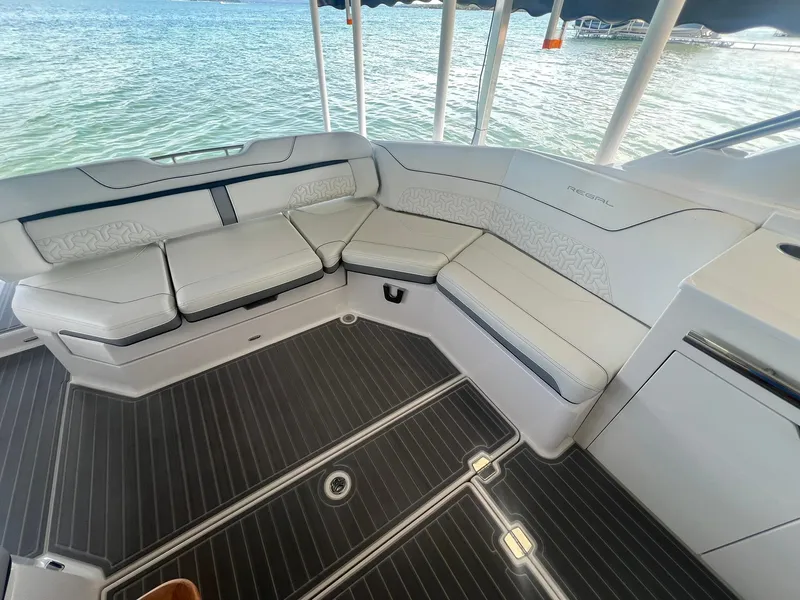 Slide: The Image of Luxurious seating area on 2022 Regal LS36 boat with elegant design and waterfront view. - 16