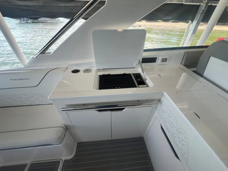 Slide: The Image of 2022 Regal LS36 boat interior with sleek kitchen area and modern design. - 18