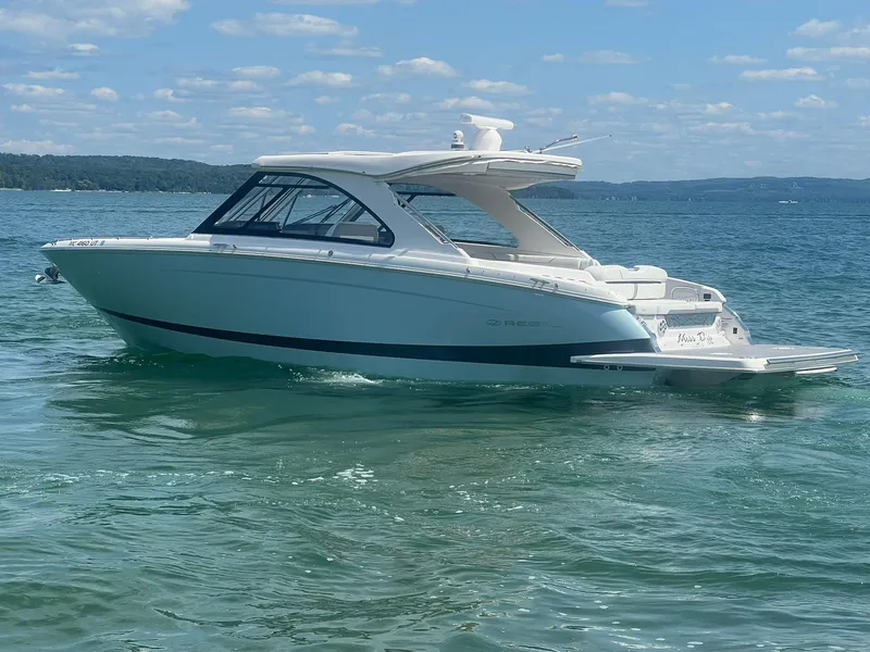 Slide: The Image of 2022 Regal LS36 boat on clear water under a blue sky. - 2