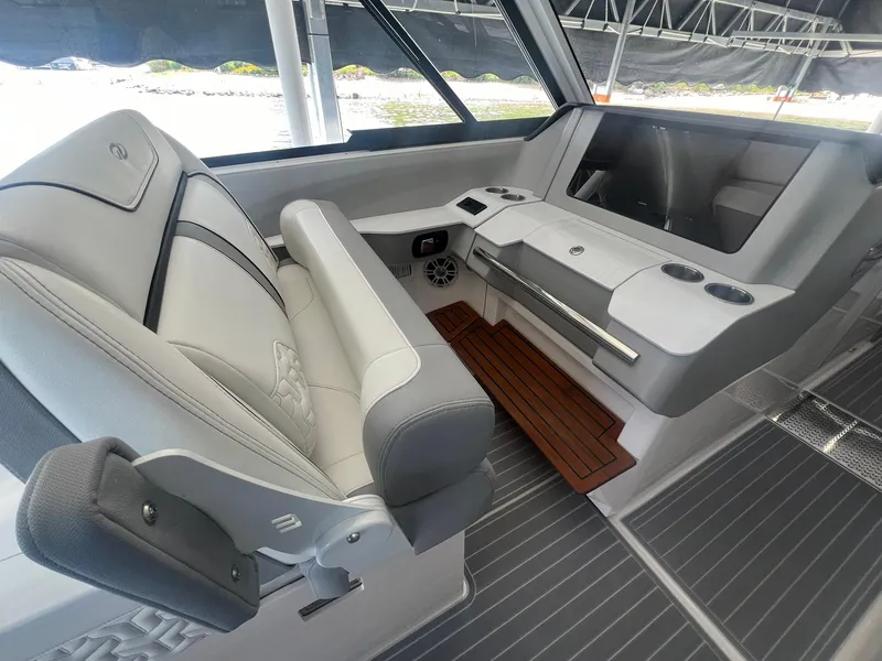 Slide: The Image of 2022 Regal LS36 boat interior with luxurious seating and modern dashboard design. - 20