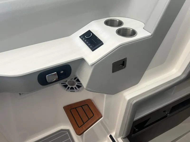 Slide: The Image of 2022 Regal LS36 boat interior with cup holders and control panel. - 22