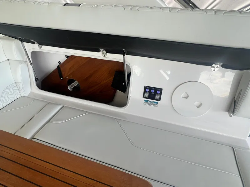 Slide: The Image of 2022 Regal LS36 boat interior with storage compartment and control panel. - 23
