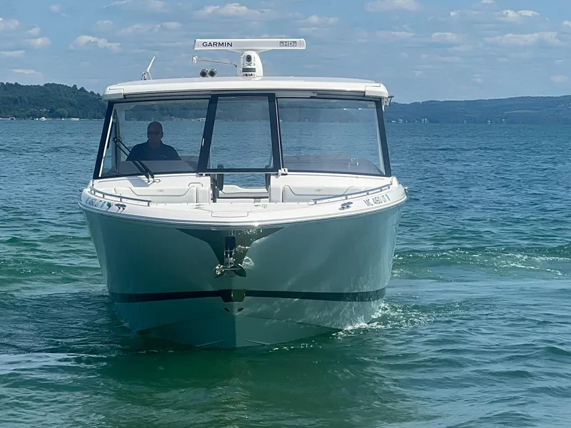 Slide: The Image of 2022 Regal LS36 boat on clear water with Garmin equipment, under a blue sky. - 4