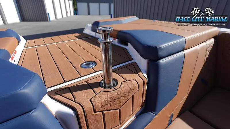 Slide: The Image of 2025 Nautique Super Air Nautique GS22 boat interior with brown and blue upholstery. - 10