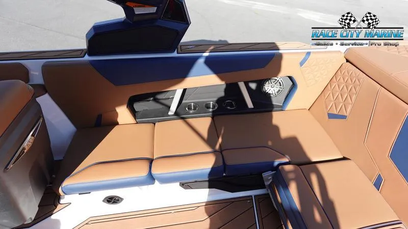 Slide: The Image of 2025 Nautique Super Air Nautique GS22 interior with tan and blue seating. - 18