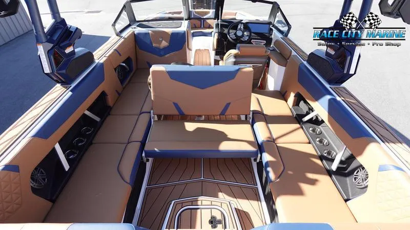 Slide: The Image of Luxurious interior of 2025 Nautique Super Air Nautique GS22 boat with tan and blue seating. - 19