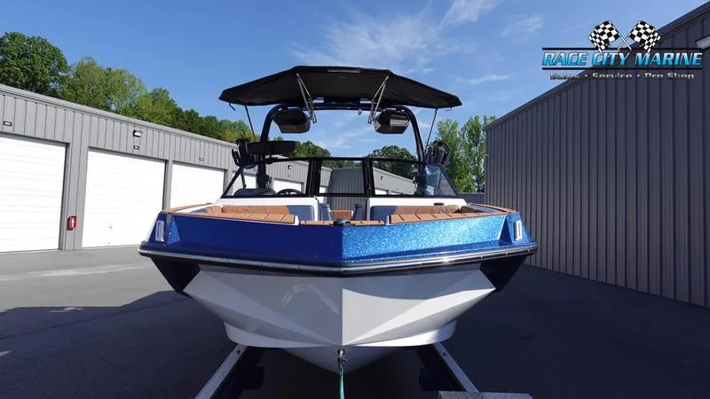 Slide: The Image of 2025 Nautique Super Air Nautique GS22 boat, blue and white, parked at Race City Marine. - 2