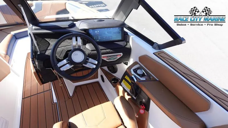 Slide: The Image of 2025 Nautique Super Air Nautique GS22 boat interior with modern dashboard and steering wheel. - 21