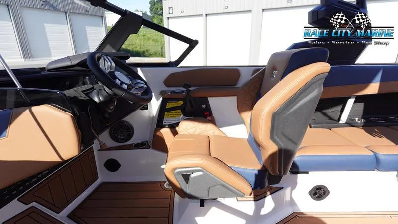 Slide: The Image of 2025 Nautique Super Air Nautique GS22 interior with tan and black seating. - 22