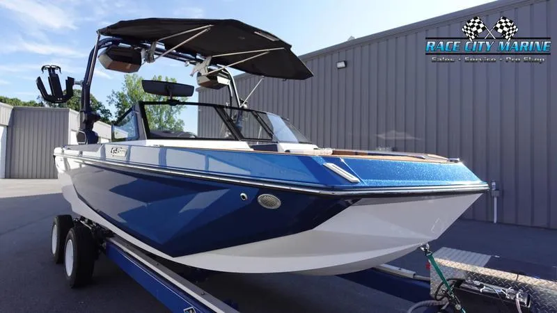 Slide: The Image of 2025 Nautique Super Air Nautique GS22 boat in blue, parked at Race City Marine. - 3
