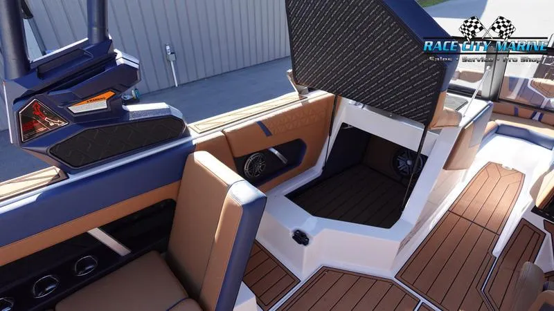 Slide: The Image of 2025 Nautique Super Air Nautique GS22 interior with open storage compartment. - 36