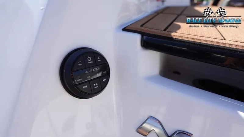 Slide: The Image of 2025 Nautique Super Air Nautique GS22 audio controls on sleek white boat exterior. - 39