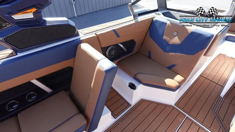 Slide: The Image of 2025 Nautique Super Air Nautique GS22 interior with tan and blue seating. - 41