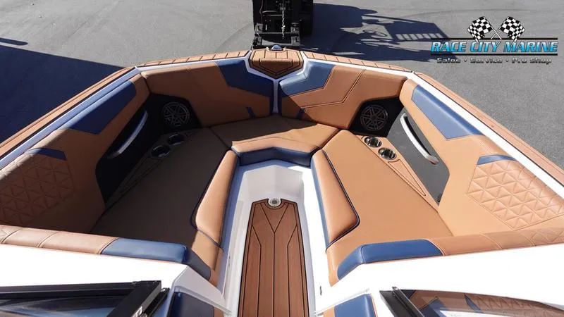 Slide: The Image of 2025 Nautique Super Air Nautique GS22 boat interior with tan and blue seating. - 44