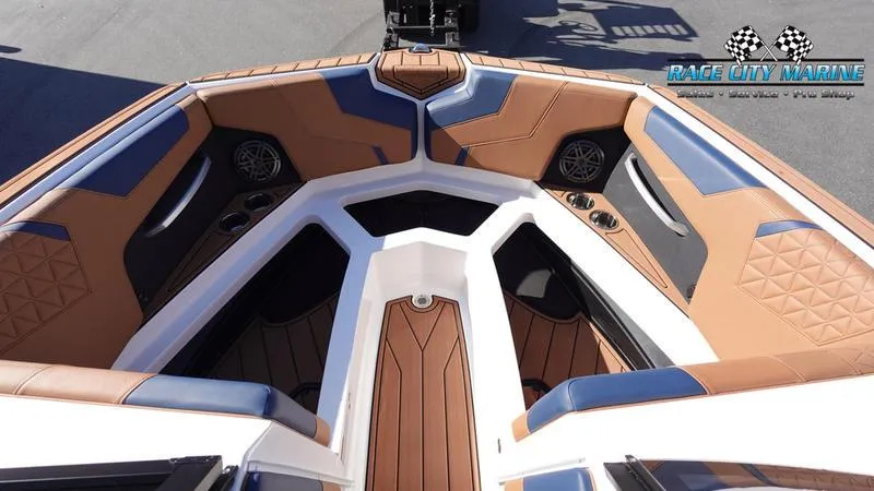 Slide: The Image of 2025 Nautique Super Air Nautique GS22 boat interior with tan and blue seating. - 45