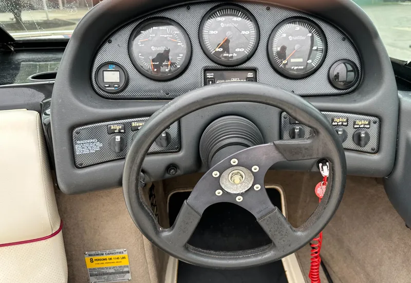 Slide: The Image of Steering wheel and dashboard of a 2000 Malibu Response LXi boat. - 11