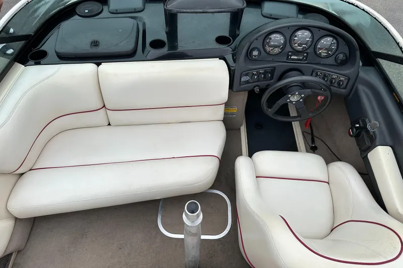 Slide: The Image of 2000 Malibu Response LXi boat interior with white seating and dashboard controls. - 13