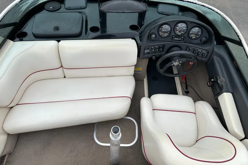 Slide: The Image of 2000 Malibu Response LXi boat interior with white seating and dashboard controls. - 14
