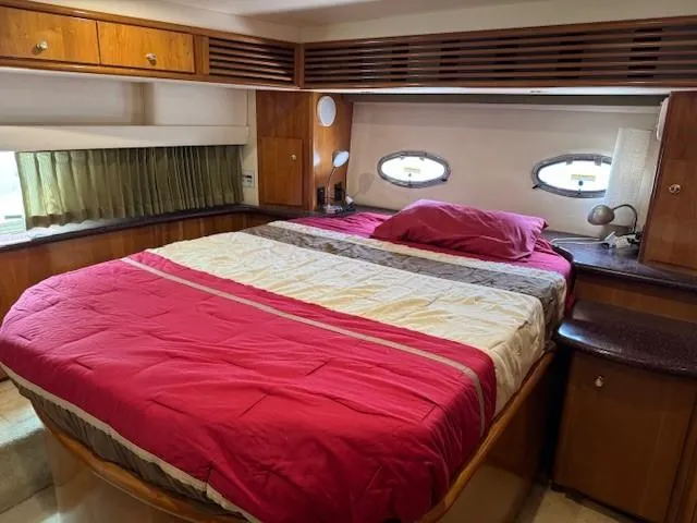 Slide: The Image of Interior of 2001 Carver 396 Motoryacht bedroom with bed and wooden cabinetry. - 11