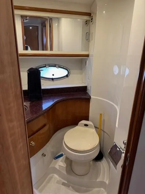 Slide: The Image of Bathroom interior of 2001 Carver 396 Motoryacht with toilet, sink, and porthole window. - 12
