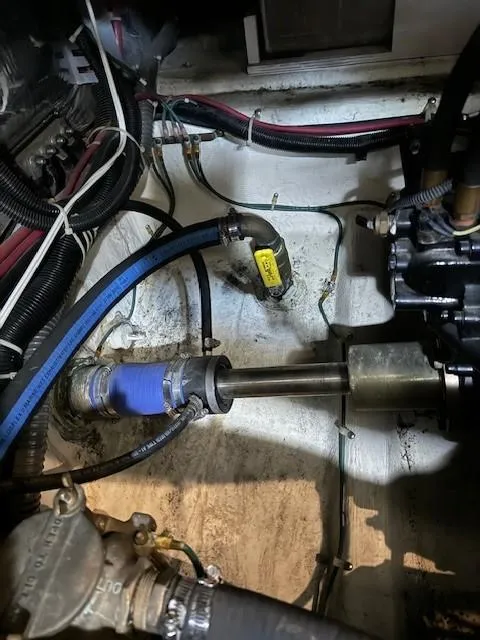 Slide: The Image of Engine compartment of a 2001 Carver 396 Motoryacht, showing mechanical components and hoses. - 17