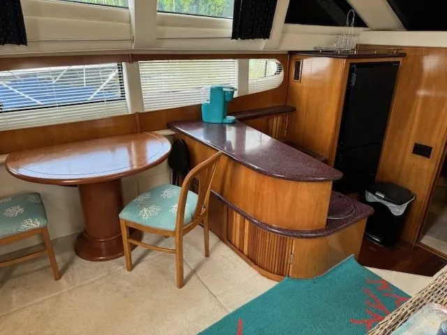 Slide: The Image of Interior of 2001 Carver 396 Motoryacht with dining area and kitchenette. - 8