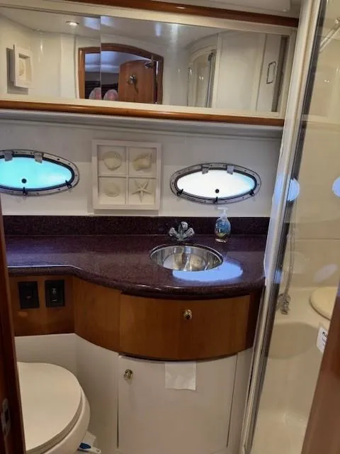 Slide: The Image of Luxurious bathroom in 2001 Carver 396 Motoryacht with elegant fixtures and porthole windows. - 13