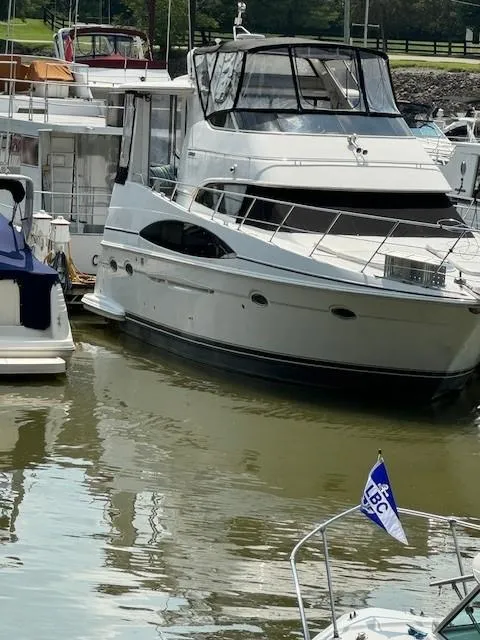 Slide: The Image of 2001 Carver 396 Motoryacht docked in a marina, surrounded by other boats. - 15