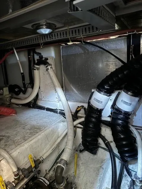 Slide: The Image of Engine room of a 2001 Carver 396 Motoryacht with visible hoses and wiring. - 20