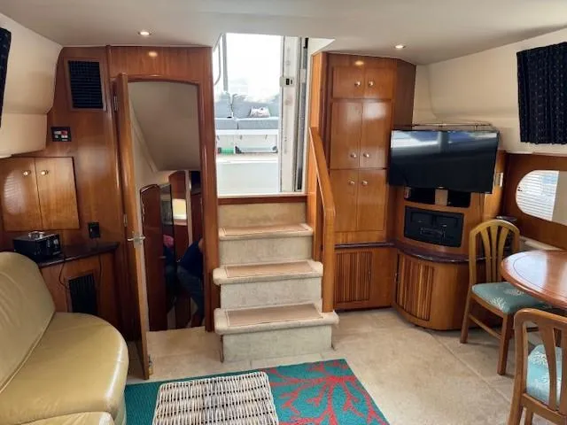 Slide: The Image of Interior of 2001 Carver 396 Motoryacht with wood cabinetry, seating, and entertainment area. - 7