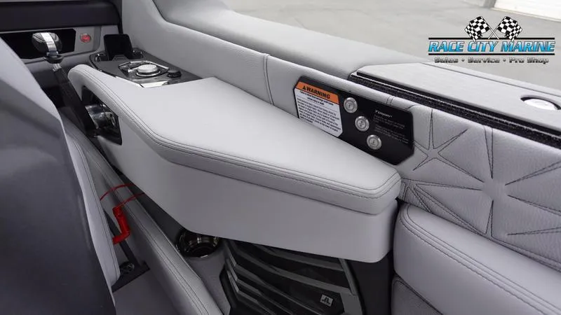 Slide: The Image of Interior of 2025 Nautique Super Air Nautique G25 Paragon boat, featuring sleek seating and controls. - 22