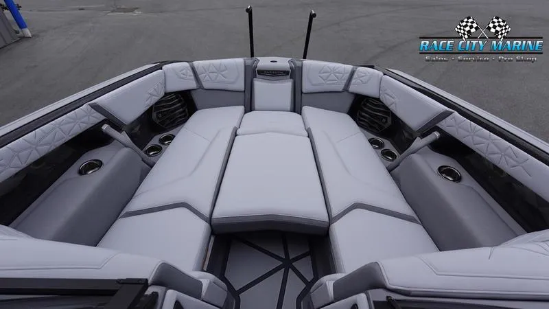 Slide: The Image of 2025 Nautique Super Air Nautique G25 Paragon interior with luxurious seating and cup holders. - 28