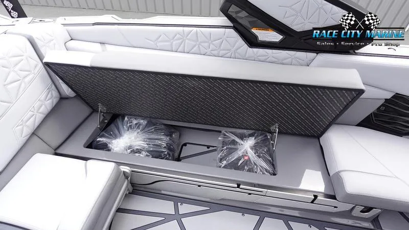 Slide: The Image of 2025 Nautique Super Air G25 Paragon interior storage compartment with sleek design and ample space. - 32