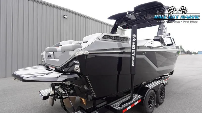 Slide: The Image of 2025 Nautique Super Air Nautique G25 Paragon boat on trailer, Race City Marine branding. - 4